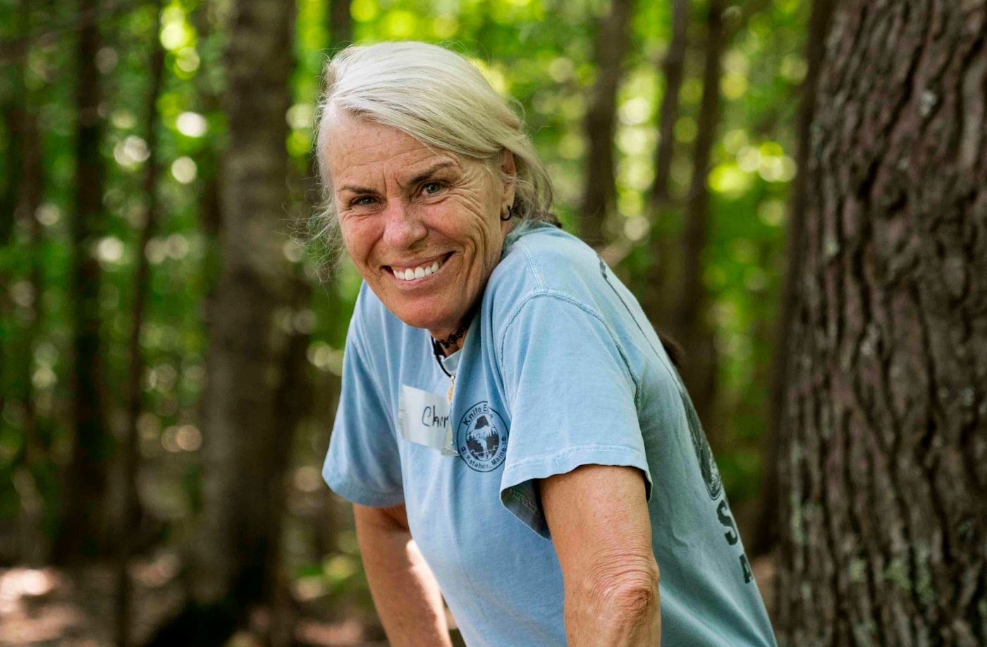 Vibrant woman in her 60s enjoying a hike in the forest